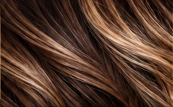 Close-up of long brunette hair with caramel highlights